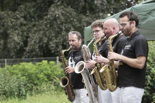 4 men playing the saxophone