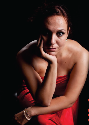 A woman in front seated in a red dress